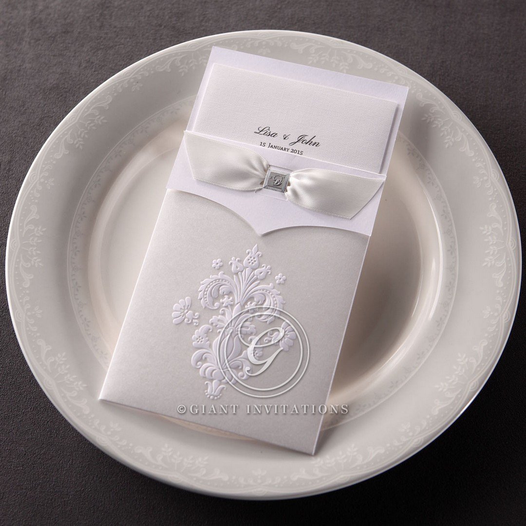 White matte wedding invitation featuring embossed Victorian pattern and tri fold insert; thermography printed